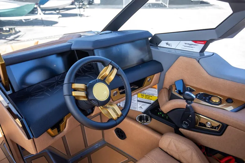 Slide: The Image of 2024 Nautique G23 boat dashboard with modern controls and luxurious design. - 35