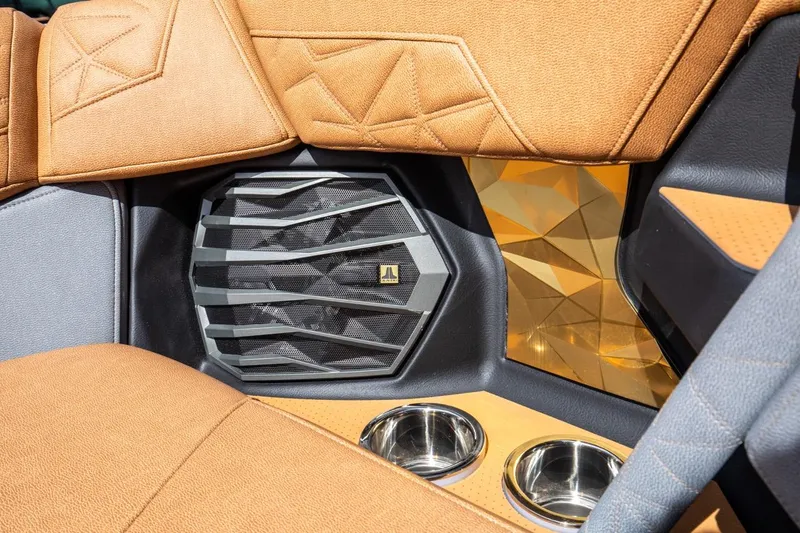Slide: The Image of 2024 Nautique G23 interior with premium speaker and cup holders. - 36