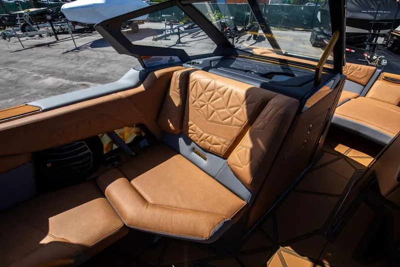 Slide: The Image of 2024 Nautique G23 boat interior with luxurious tan leather seating. - 37