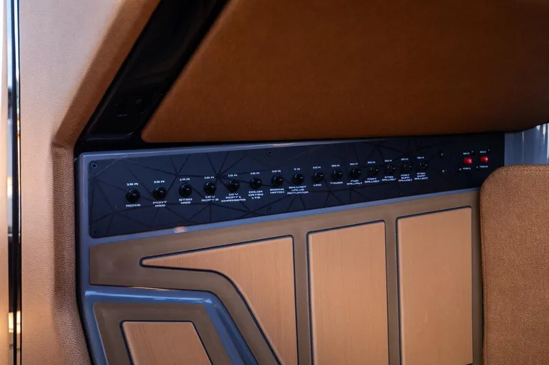 Slide: The Image of 2024 Nautique G23 control panel with switches and buttons. - 39