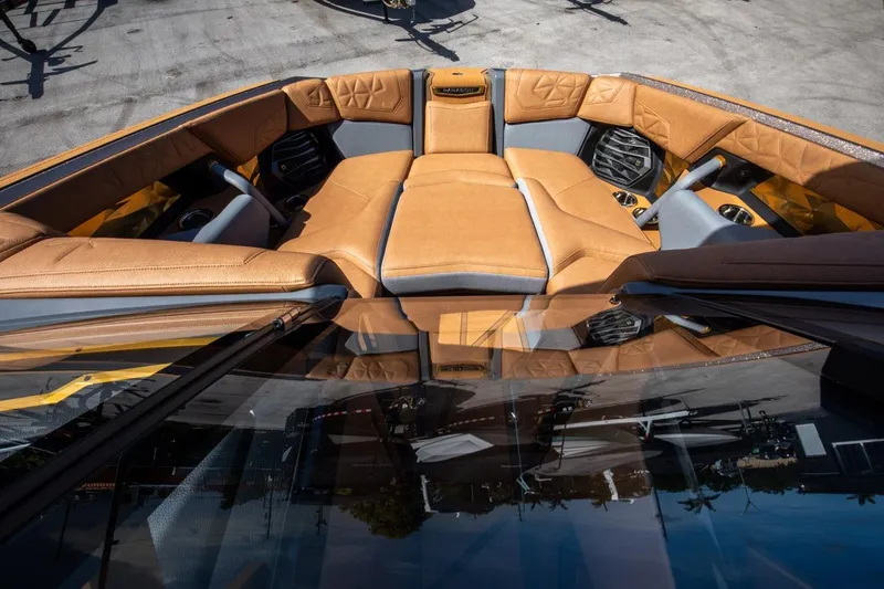 Slide: The Image of 2024 Nautique G23 boat interior with luxurious tan seating and modern design. - 42
