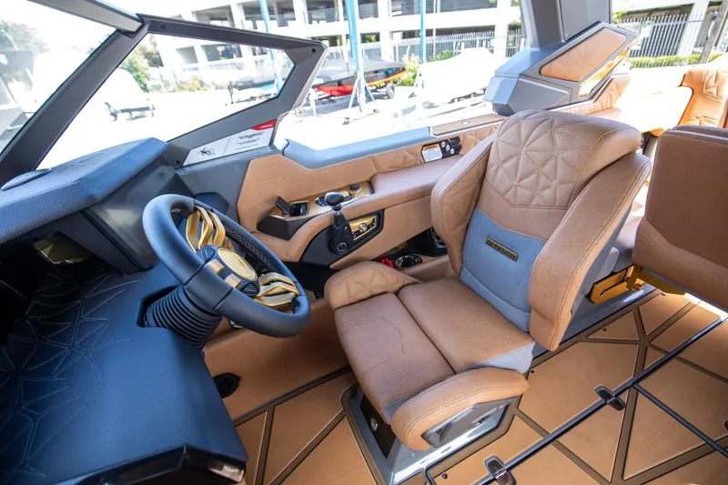 Slide: The Image of 2024 Nautique G23 boat interior with luxurious captain's seat and advanced steering console. - 43