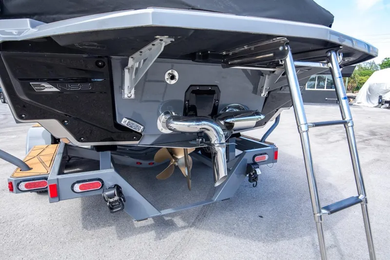 Slide: The Image of 2024 Nautique G23 boat stern with propeller and ladder. - 44