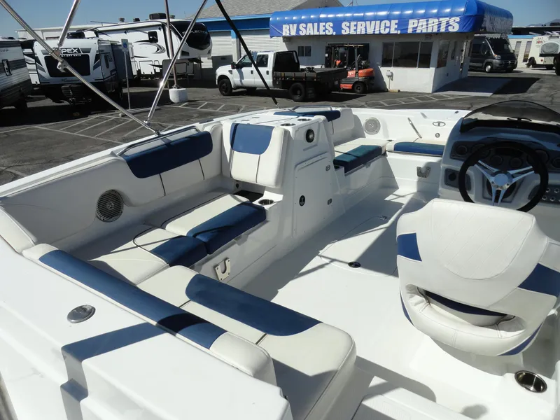 Slide: The Image of 2020 Tahoe 1950 boat interior with white and blue seating at RV sales lot. - 12