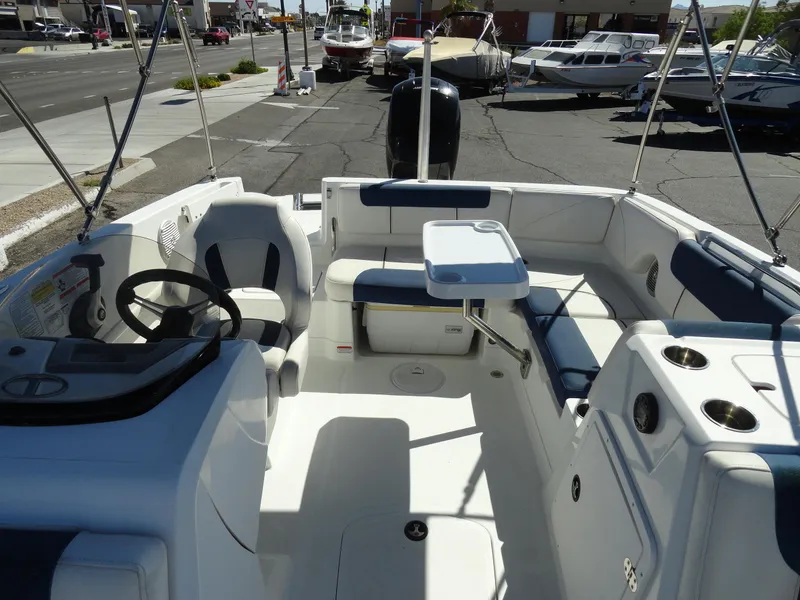 Slide: The Image of Interior of a 2020 Tahoe 1950 boat with seating and steering wheel. - 16