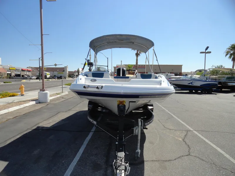 Slide: The Image of 2020 Tahoe 1950 boat on trailer in parking lot, front view. - 2