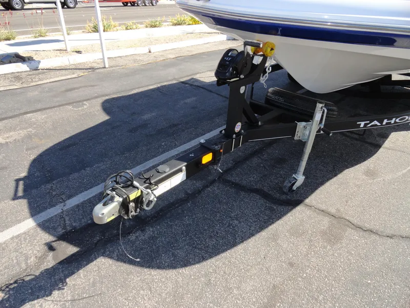 Slide: The Image of Trailer hitch of a 2020 Tahoe 1950 boat on pavement. - 20