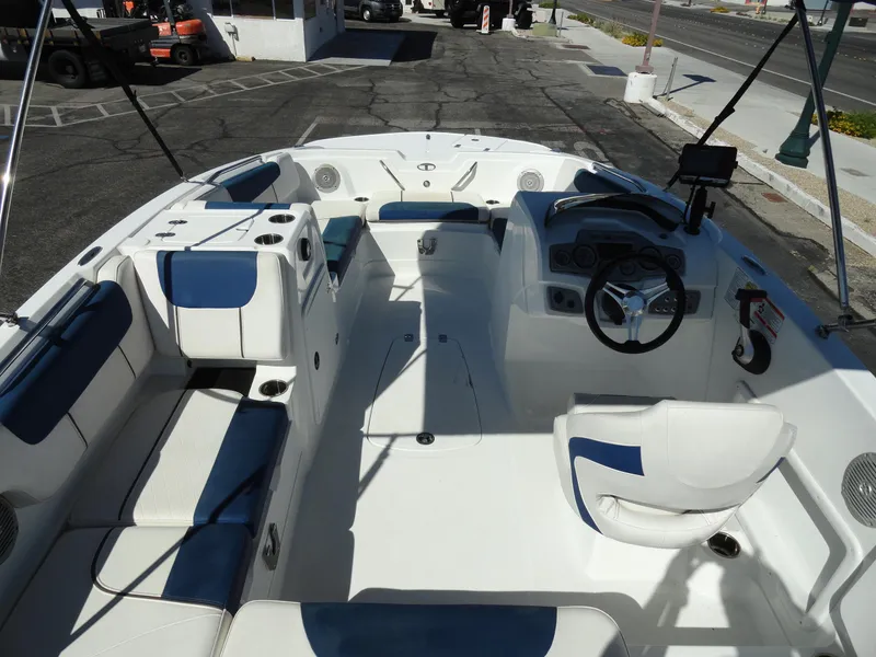 Slide: The Image of 2020 Tahoe 1950 boat interior with white and blue seating, steering wheel, and dashboard. - 5