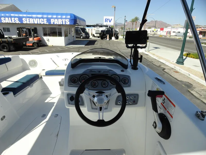 Slide: The Image of Cockpit of a 2020 Tahoe 1950 boat at a dealership with sales, service, and parts. - 7