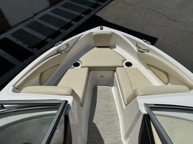 Slide: The Image of 2019 Regal 1900 ES Bowrider boat interior with beige seating and cup holders. - 10