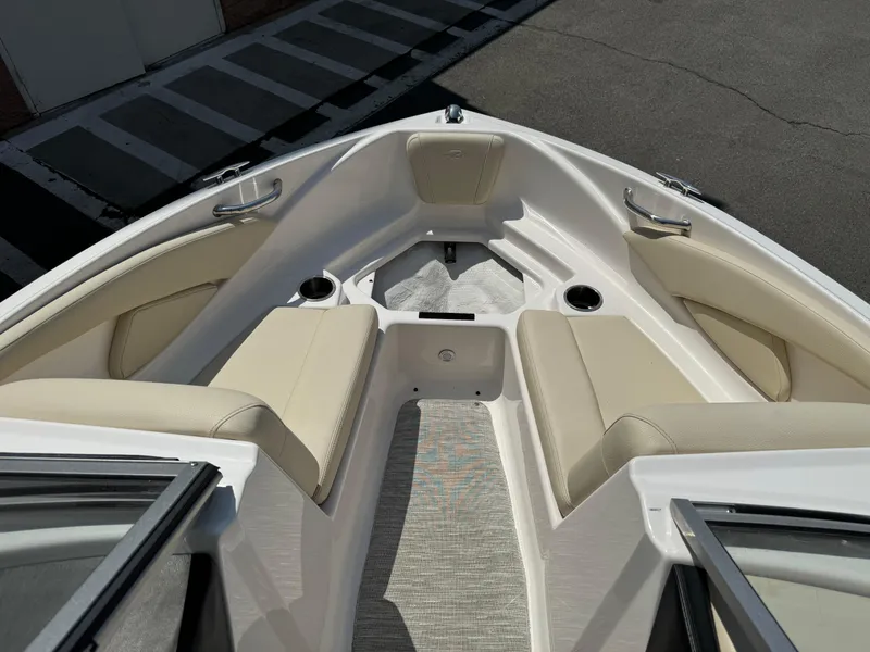 Slide: The Image of 2019 Regal 1900 ES Bowrider boat interior with beige seating and cup holders. - 11