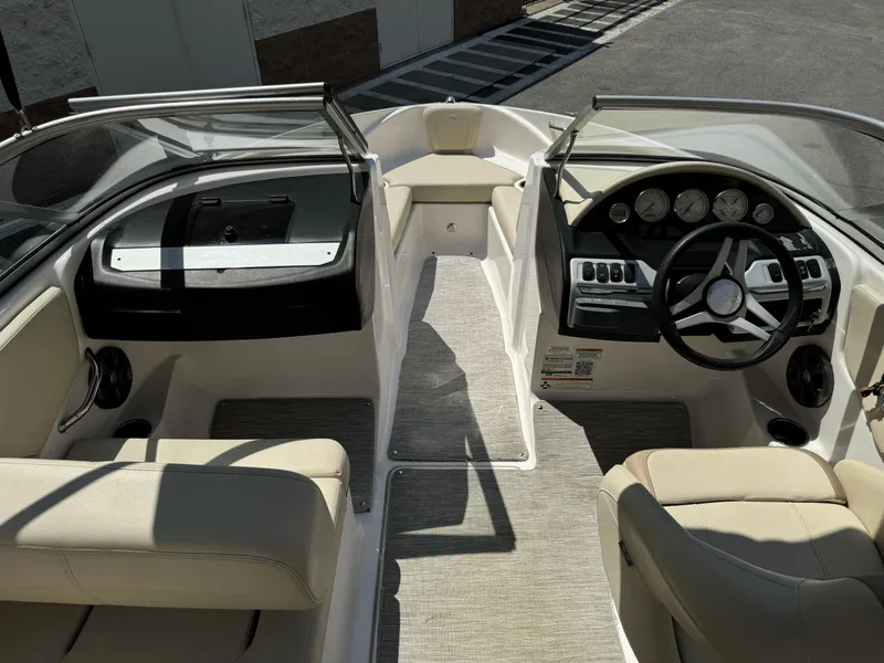 Slide: The Image of 2019 Regal 1900 ES Bowrider interior with beige seating and modern dashboard. - 12