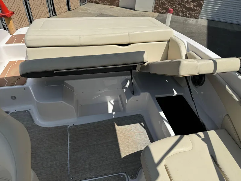 Slide: The Image of 2019 Regal 1900 ES Bowrider interior with beige seating and storage compartments. - 18