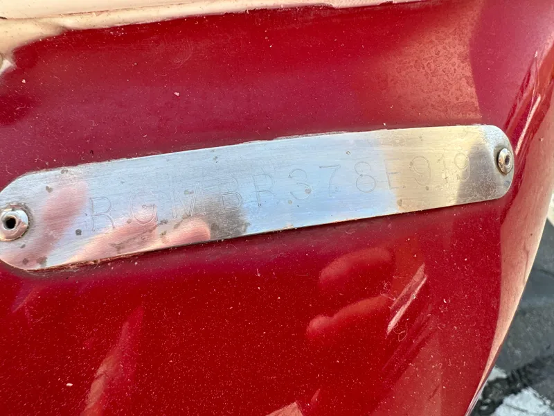 Slide: The Image of 2019 Regal 1900 ES Bowrider boat identification plate on red hull. - 21