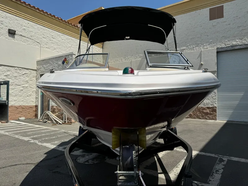 Slide: The Image of 2019 Regal 1900 ES Bowrider boat on trailer in a parking lot. - 3