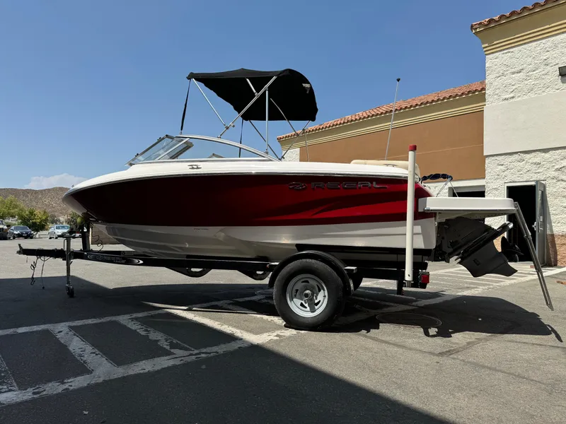 Slide: The Image of 2019 Regal 1900 ES Bowrider boat on a trailer in a parking lot. - 5