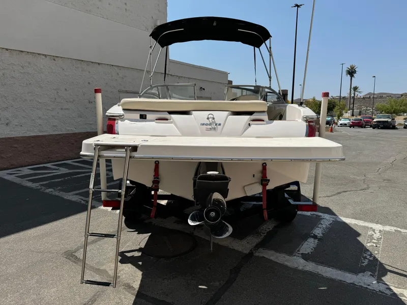 Slide: The Image of 2019 Regal 1900 ES Bowrider boat with ladder and canopy in parking lot. - 6