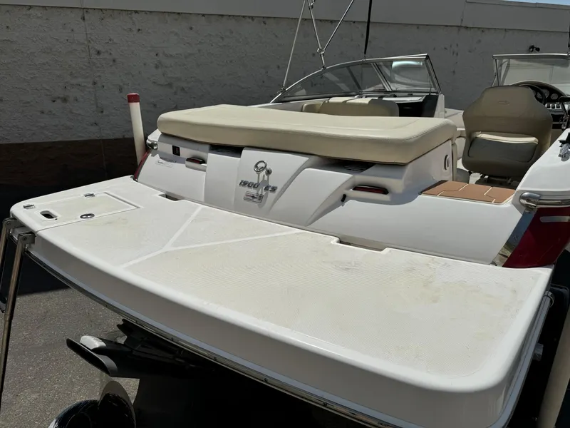 Slide: The Image of 2019 Regal 1900 ES Bowrider boat with swim platform and seating area. - 9