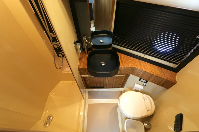 Slide: The Image of Luxurious bathroom in 2014 Azimut Magellano 43 yacht with modern fixtures and wood accents. - 11