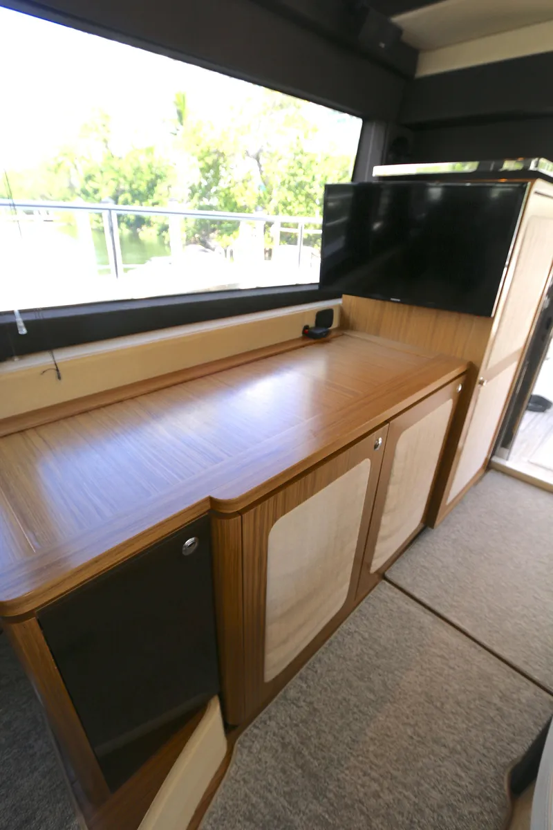 Slide: The Image of Interior of 2014 Azimut Magellano 43 yacht with wooden cabinetry and large window. - 2