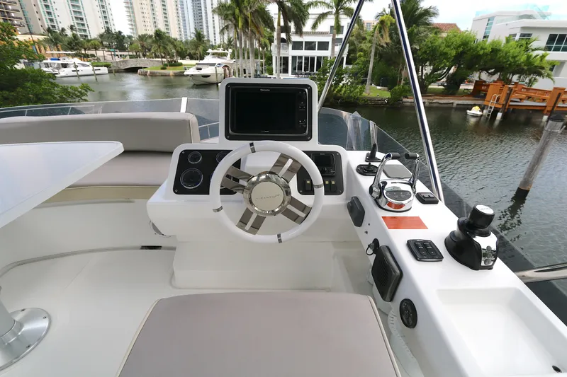 Slide: The Image of 2014 Azimut Magellano 43 yacht helm with modern controls and waterfront view. - 22