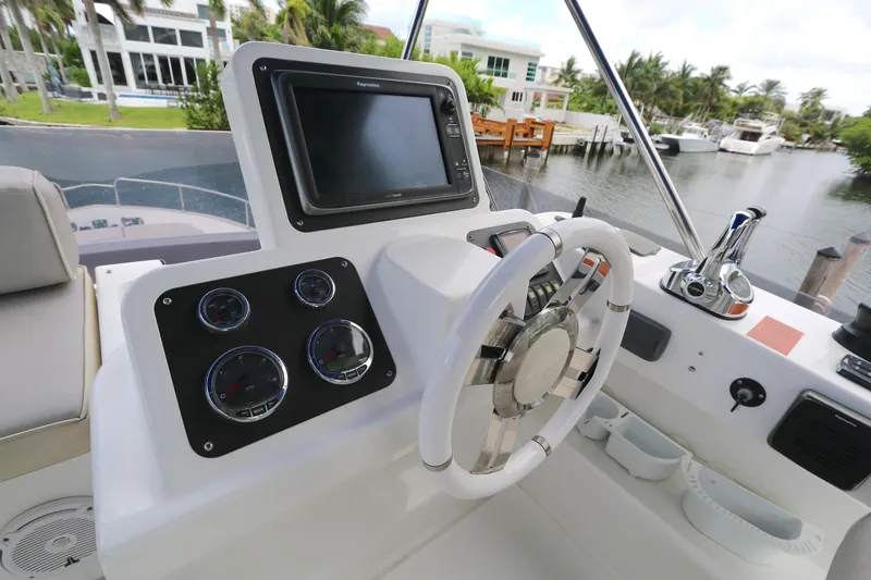 Slide: The Image of Helm of 2014 Azimut Magellano 43 yacht with steering wheel and navigation controls. - 23