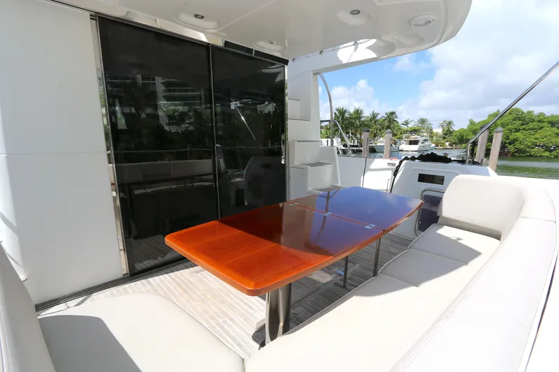 Slide: The Image of Luxurious 2014 Azimut Magellano 43 yacht deck with elegant seating and wooden table. - 27