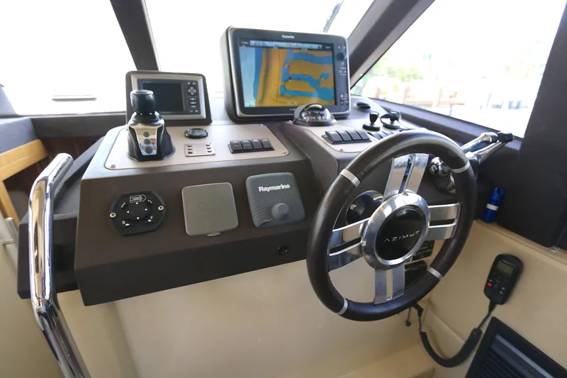 Slide: The Image of Control panel of 2014 Azimut Magellano 43 yacht with navigation equipment and steering wheel. - 4