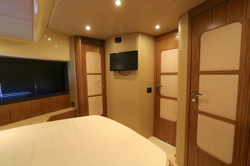 Slide: The Image of Luxurious interior of 2014 Azimut Magellano 43 yacht with modern wood paneling and TV. - 7