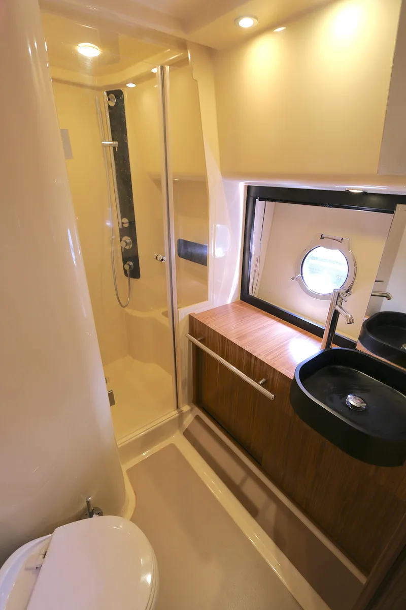 Slide: The Image of Luxurious bathroom in 2014 Azimut Magellano 43 yacht with modern fixtures and porthole window. - 8