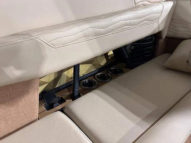 Slide: The Image of 2025 Nautique Super Air Nautique G23 interior seating and cup holders. - 15