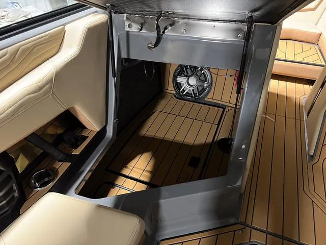 Slide: The Image of 2025 Nautique Super Air Nautique G23 interior with premium seating and sound system. - 19