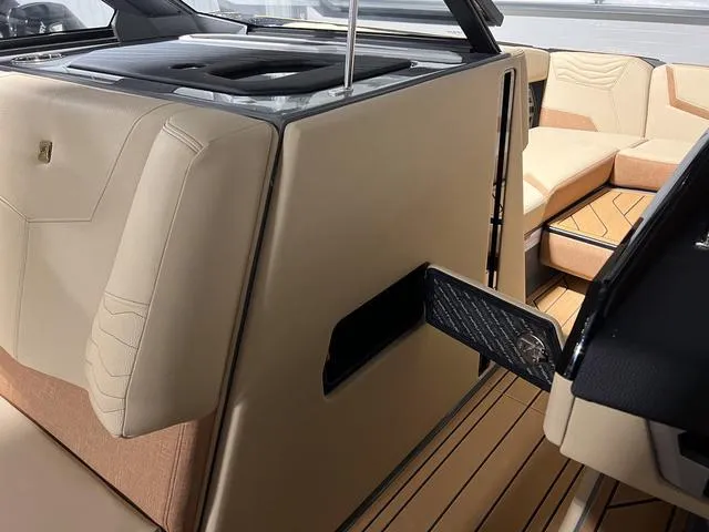 Slide: The Image of 2025 Nautique Super Air Nautique G23 interior with beige upholstery and modern design. - 26
