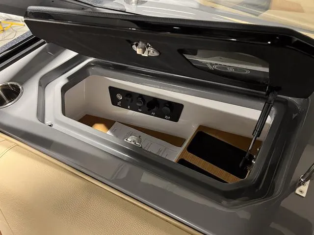 Slide: The Image of 2025 Nautique Super Air Nautique G23 storage compartment with control panel. - 27