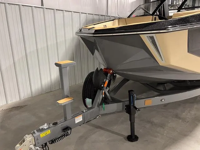 Slide: The Image of 2025 Nautique Super Air Nautique G23 boat on trailer in storage facility. - 3