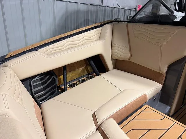 Slide: The Image of 2025 Nautique Super Air Nautique G23 interior seating with beige and brown upholstery. - 30