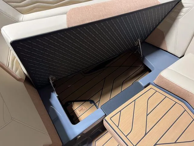 Slide: The Image of 2025 Nautique Super Air Nautique G23 storage compartment with cushioned seating. - 31
