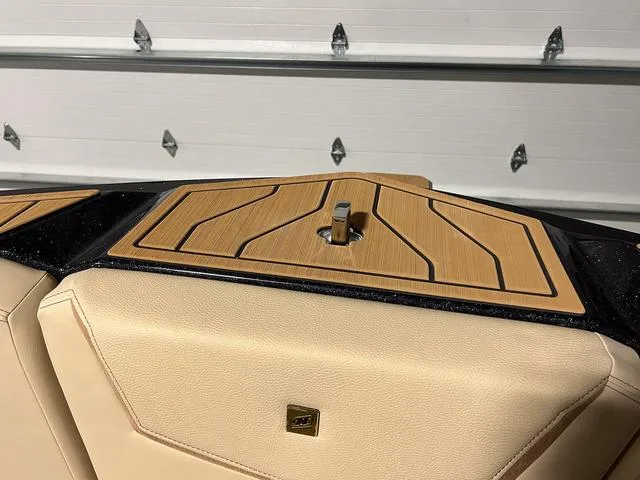 Slide: The Image of 2025 Nautique Super Air Nautique G23 boat interior with teak deck and beige upholstery. - 34