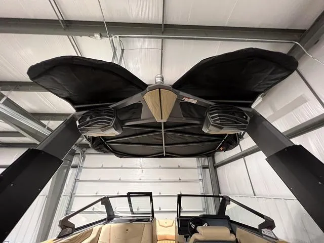 Slide: The Image of 2025 Nautique Super Air Nautique G23 boat interior with tower speakers and bimini top. - 35