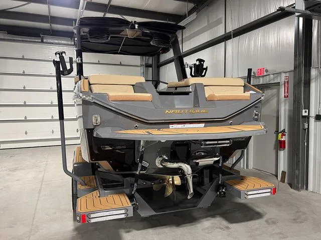 Slide: The Image of 2025 Nautique Super Air Nautique G23 boat in a storage facility. - 4
