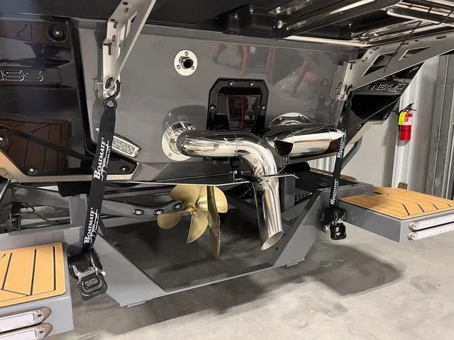 Slide: The Image of 2025 Nautique Super Air Nautique G23 boat stern with propeller and exhaust system. - 5