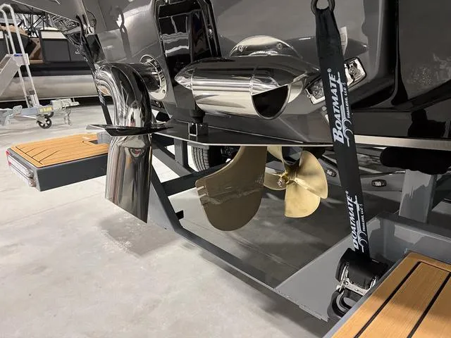 Slide: The Image of 2025 Nautique Super Air Nautique G23 boat propeller and exhaust system in a showroom. - 6