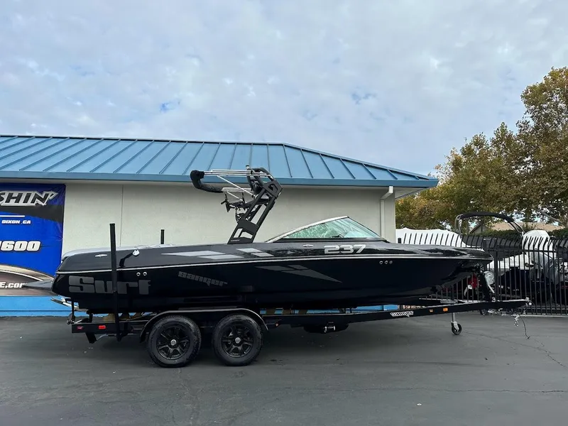 Slide: The Image of 2024 Sanger V237 SX boat on trailer, parked outdoors. - 0