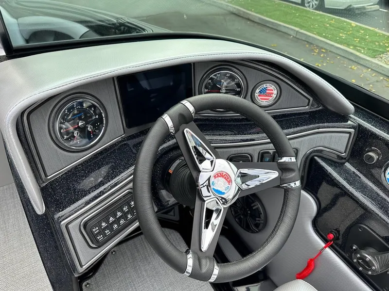 Slide: The Image of 2024 Sanger V237 SX boat dashboard with steering wheel and gauges. - 10