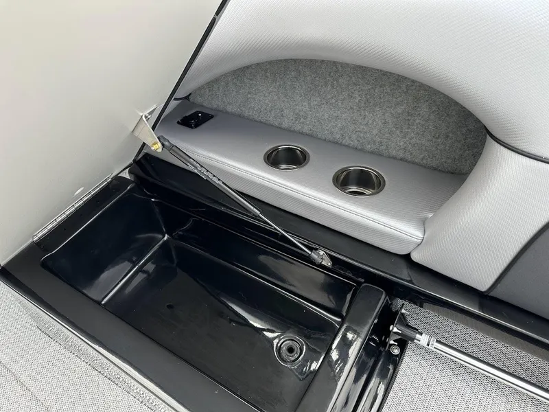 Slide: The Image of 2024 Sanger V237 SX boat storage compartment with cup holders and hydraulic lift. - 17