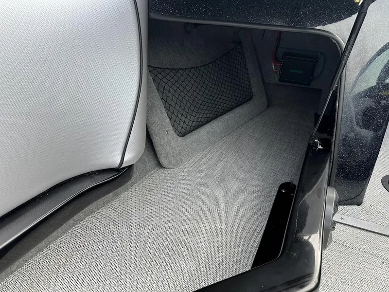 Slide: The Image of 2024 Sanger V237 SX interior storage compartment with netting and carpeted floor. - 18