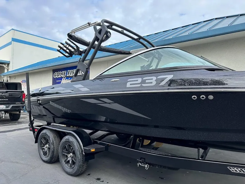 Slide: The Image of 2024 Sanger V237 SX boat on trailer, sleek black design, parked outdoors. - 3