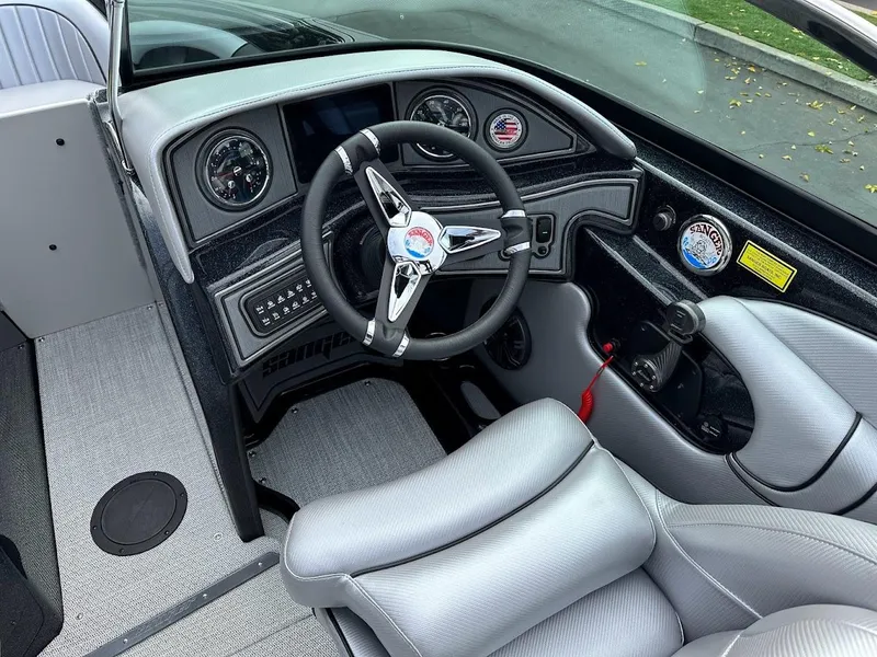 Slide: The Image of 2024 Sanger V237 SX boat interior with sleek dashboard and steering wheel. - 9