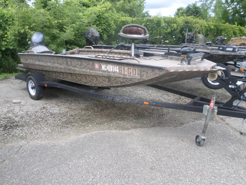 Slide: The Image of 2012 Excel 1751 VF4 camo boat on trailer with outboard motor. - 1