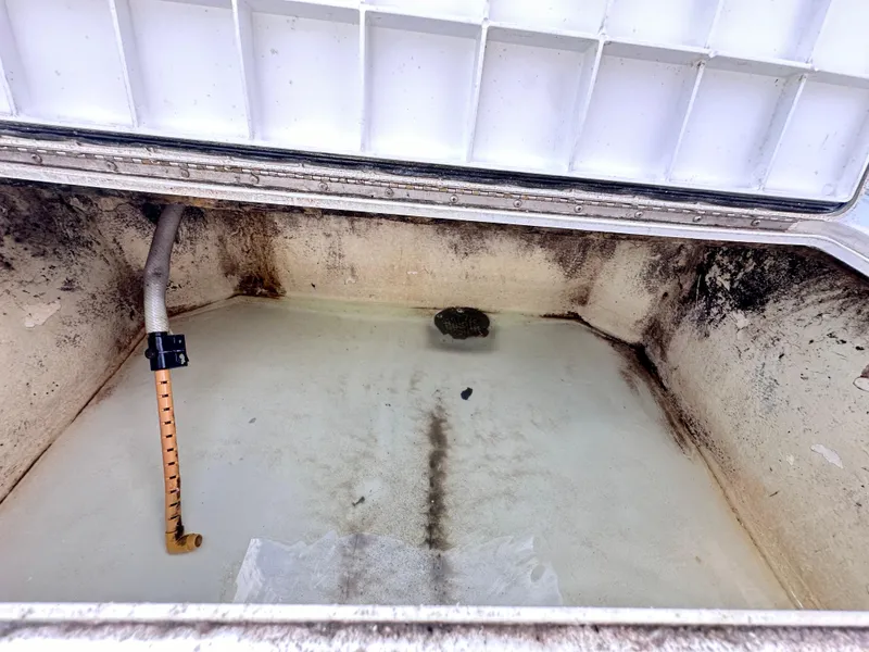 Slide: The Image of Open storage compartment of a 1988 Ocean Master 31 Center Console boat. - 28